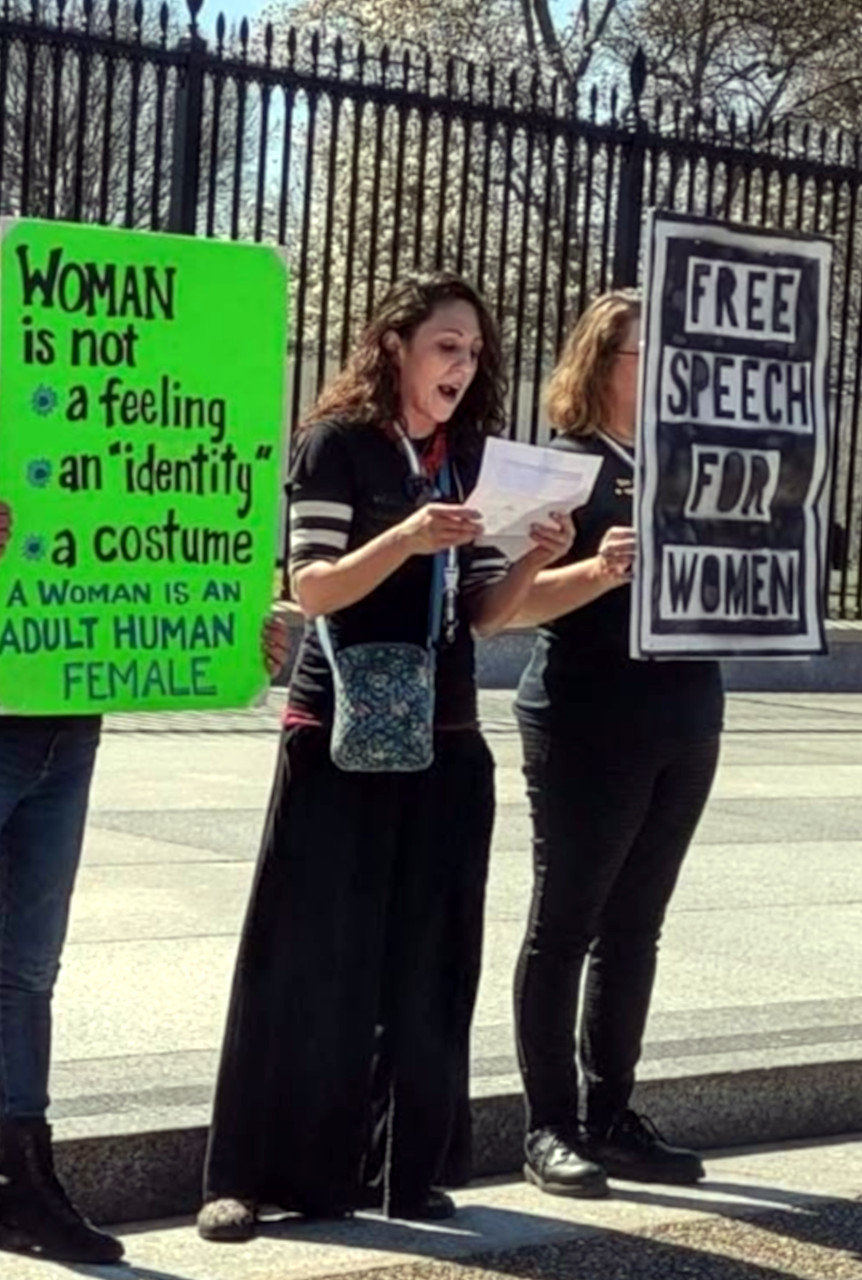 Women holding signs at Washington protest.